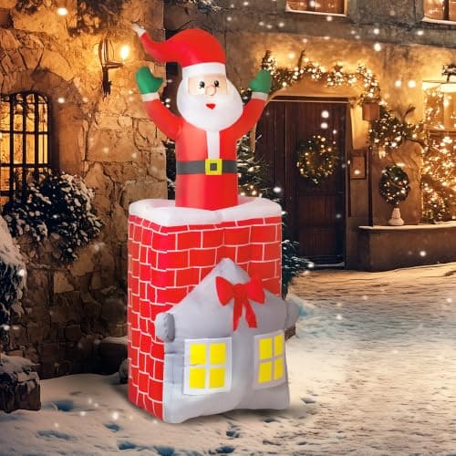 An inflatable Santa and chimney scene lit at night