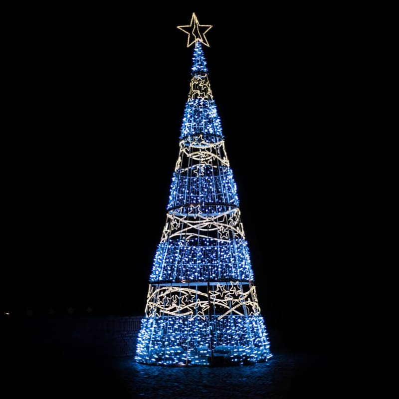 Net-style lights over a shrub at night